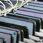 Phones lined up in a factory for charging