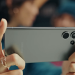 female hands with rings holding a phone