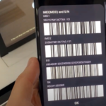 a smartphone displaying various codes and barcodes on its screen