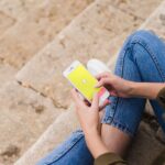 Woman sitting and using snapchat app