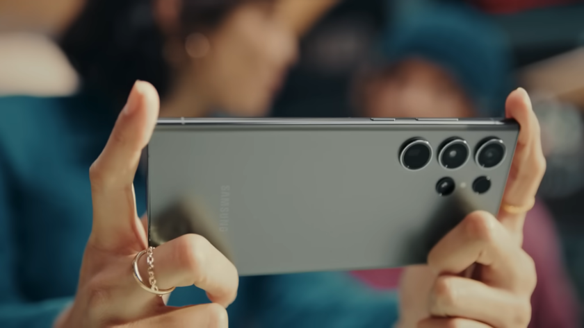 female hands with rings holding a phone
